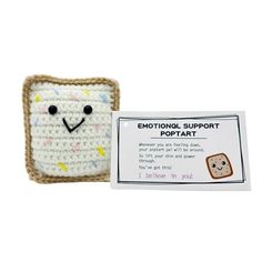 a small crocheted toast with a face on it and a card for someone to use