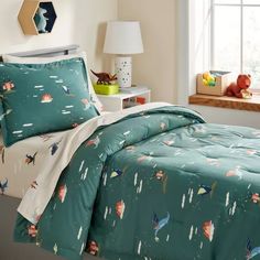 a bed room with a neatly made bed and two stuffed animals on the nightstands