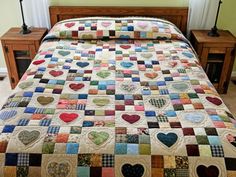 a bed with a quilt made to look like hearts