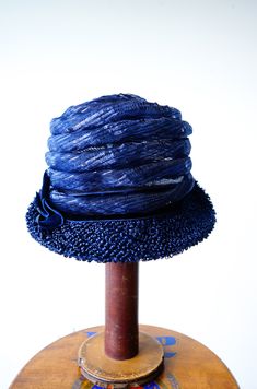 "DESCRIPTION * vintage hat from 1950s-1960s. * cloche style: close-fitting high crown, worn low on the forehead, short brim * the brim is upturned in the back * navy blue woven straw * decorated with translucent tube straw, coiling to the top of hat * hatband is wrapped with thick velvet ribbon and decorated with a bow on the side * no tag CONDITION * hat is in good condition. A small area of the tube decoration is slightly crushed as shown in the last photo. Need simple cleaning and reshaping. Retro Fitted Cloche Hat With Short Brim, Vintage Cloche Hat For Kentucky Derby Evening, Fitted Vintage Cloche Hat For Vintage Events, Vintage Evening Cloche Hat For Kentucky Derby, Fitted Flapper Cloche Hat With Brim, Retro Mini Hats With Curved Brim For Evening, Retro Mini Hat With Short Brim For Evening, Retro Wide Brim Mini Hat, Fitted Vintage Cap