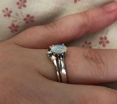 "A unique oval-shaped faceted rainbow moonstone engagement ring set accented with 2 petite genuine blue sapphires complemented with a matching contour wedding band featuring genuine blue and white sapphires handcrafted in sterling silver. Wrapped in a box ready for gift-giving.(r-egt-9) Instagram Video --------------- https://instagram.com/p/Bl3qWYXFgUA/ Can be custom made in any material and gemstones Center stone measure 7mm x 6mm Side Stone measures 2.2mm ----> Please note there is an addi Elegant Sapphire Moonstone Ring In Oval Shape, White Gold Sapphire Ring With Gemstone Accents For Wedding, Wedding White Gold Sapphire Ring With Gemstone Accents, Elegant Sapphire Color Moonstone Ring, Wedding Sapphire Ring With Gemstone Accents In Sterling Silver, Oval Cabochon Sapphire Ring For Wedding, Oval Sapphire Ring With Gemstone Accents For Wedding, Moonstone And Sapphire Wedding Ring, Wedding Sapphire Ring Oval Cabochon