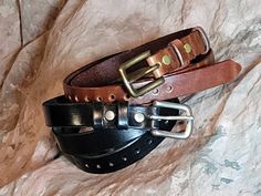 I have gotten a few requests for a plain brown, dark brown, mahogany (red brown) or black semi gloss leather hat belt and I thought, why not?    Also available in natural, no dye, clear finish only version Made from quality Herman Oak leather, this band will put a more dressy finish on your hat than our distressed crazy horse bands.   And it doesn't have to be plain.  I can rivet it up as well with rivets spaced down the bands length.   Available in 1 1/2", 1 3/16", 1", 3/4" ,5/8", 1/2" or 3/8" Affordable Brown Hat Bands For Fall, Leather Hats, Steampunk Costume, Hat Band, Hat Sizes, Caps Hats, Accessories Hats, Cowboy, Bathing Beauties