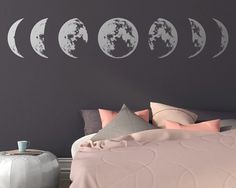 the moon phases wall decals are shown in this bedroom