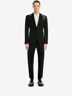 Elevate your style to the extraordinary with our Men's Embellished Harness Jacket Black Suit. This bespoke ensemble redefines traditional suiting, featuring a meticulously designed harness jacket that adds a contemporary edge to the classic black suit. The single-button closure and regular-fit design make it suitable for a range of occasions, from formal parties to weddings. Crafted from high-quality cotton suiting, the fabric offers both comfort and sophistication, allowing you to exude confidence throughout any event. The jacket is embellished with intricate detailing, adding a unique and fashion-forward touch to the outfit. The accompanying black pantsuit completes the look with a tailored fit that emphasizes your silhouette and provides a polished appearance. Whether you're attending a Luxury Long Sleeve Suits For Party, Luxury Long Sleeve Party Suits, Luxury Party Suits, Luxury Embellished Party Suit, Elegant Fitted Embellished Pantsuit, Party Tuxedo Pantsuit With Long Sleeves, Fitted Tuxedo Blazer For Party Season, Luxury Notch Lapel Pantsuit For Wedding, Luxury Notch Lapel Wedding Pantsuit