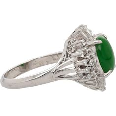 This platinum cathedral set ring presents stunning filigree along the bridge. A luscious natural green jade stone rests at the rings head. Certified by The Hong Kong jade and Stone lab this glorious jade boasts 1.73 carats and an oval cut. Perfectly placed in a brilliant halo are shining white diamond, featuring both a tapered baguette and round cut and totaling .63 carats. This rings size is 6.5 and adjustable. A sparkling ring like this is sure to dazzle and captivate the eye.   Item Details: Type: Ring Metal: Platinum 900 Weight: 8.72 Grams Size: 6.5 Setting: Cathedral, Filigree  Center Stone Details: Type: Natural Jade Carat: 1.73 Cut: Oval Color: Bright Green Untreated  Natural Type A (Fei Cui) Transparency: Translucent   HK Jade and Stone Lab Certified   Side Stone Details: Type: Nat Panther Ring, 22k Gold Ring, Art Deco Sapphire Ring, Sapphire Eternity Ring, Oval Sapphire Ring, Sapphire Cocktail Ring, Art Nouveau Ring, Turquoise Gold Ring, Cameo Ring