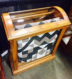 a wooden case sitting on top of a carpeted floor