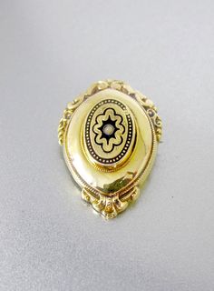 Fabulous antique Victorian locket in rendered in 14K on the front and 9K Yellow Gold on the back. This beautifully detailed oval shaped dimensional locket has ornate floral embossed repousse scrollwork at the top and bottom with a raised panel with lovely black enamel tracery design around the center and a small seed pearl accent. The back of this wonderful locket has a hinged glass door ready to add a lock of hair, personal memento or picture of a loved one! A perfect example of Victorian mourn Enamel Locket, Gold Car, Lock Of Hair, Victorian Locket, Engraved Locket, Picture Locket, Oval Locket, Antique Collectors, Retro Shop