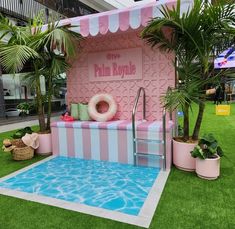 a pink and white building with a pool in the middle