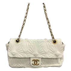 Chanel Paris-Venice Ca D‚ÄôOro Flap Bag Seashell 3D Embroidered Flap Bag 2009 Large Off White This item is a genuine CHANEL Lambskin Quilted Ca D'Oro Flap in Off White. The elegant handbag bag is exquisitely crafted from soft lambskin leather and showcases intricate embroidery. It boasts shoulder straps made of gold chain links with leather threading, as well as a front flap adorned with a gold-tone Chanel CC turn lock. CONDITION: EXCELLENT Light creases on the bottom. Rubbing around the corners Designer Formal Bag With Embossed Details, Luxury Embossed Shoulder Bag, Designer Embossed Formal Bag, Designer Embossed Bags For Formal Occasions, Designer Formal Embossed Bags, Luxury White Quilted Shoulder Bag, White Quilted Evening Bag, White Quilted Bag For Formal Occasions, Designer White Bag With Embroidered Logo