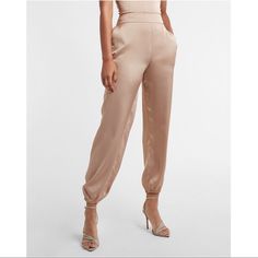 Express High Waisted Satin Pull-On Jogger Pant Desert Khaki 2655 Size: Xl (Petite) A Combo Of Satin And Soft Stretch Fabric Make These Joggers A Comfortable And Stylish Choice. Perfect For Stepping Into The Office Or Out On The Town. Features & Fabric High Waisted Stretch Pull-On Waistband Satin; Slant Hand Pockets Stretch Ankle Cuffs Inseams: Petite 23.5" Petite: Perfectly Proportioned Rise, Inseam And Design Polyester Joggers Women, Satin Joggers, Cropped Cargo Pants, Tie Waist Jumpsuit, Ankle Dress Pants, Grey Trousers, Stretchy Leggings, Compression Leggings, Womens Dress Pants