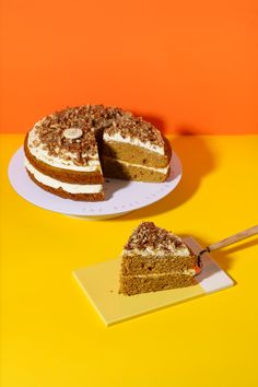 a piece of cake sitting on top of a white plate next to a slice of cake