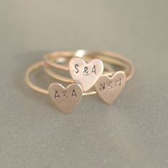 Our tiniest initials ever, on the sweetest little 14k gold filled heart. Personalize your heart with best friend, couples or kids initials. So dainty and adorable, its like wearing a secret keepsake. Our gold heart stacking ring is custom made to order in your size hand stamped with your letters. Shown with 1.5 mm uppercase letters. Font also available in 1.5 mm lowercase. See drop-down menu for additional initial options. ** This listing is for ONE gold heart initial ring. Use the drop-down... 14k Gold Filled Stackable Rings For Anniversary, Cute Rose Gold Wedding Rings, Dainty Heart Charm Stackable Rings For Wedding, Dainty Stackable Rings With Heart Charm For Wedding, Dainty Stackable Wedding Rings With Heart Charm, Dainty Wedding Stackable Rings With Heart Charm, Minimalist Personalized Heart Initial Ring, Dainty Stackable Rings With Initials For Promise, Gold Stackable Rings With Heart Charm For Wedding