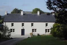 a white house with black roof and windows