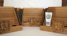 four wooden boxes with toothbrushes and toothpaste in them