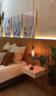 a bed sitting in a bedroom next to a window with blinds on the windowsill