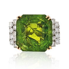 The August birthstone, peridot, symbolizes strength. ... It was once believed that the green peridot crystals found in volcanic ashes were the tears of the volcano goddess, Pele. When set in gold, this gem was said to protect the wearer from nightmares. Bright green emerald cut peridot cocktail ring with brilliant cut Formal Peridot Gemstones For May Birthstone, Green Peridot Birthstone Gemstones, Green Peridot Gemstones As Birthstones, Green Peridot Diamond Ring With Accent Stones, Green Diamond Gemstones For May Birthstone, Green Peridot Jewelry With Center Stone, Collectible Green Emerald Ring With Center Stone, Collectible Green Diamond Jewelry, Green Jewelry With Accent Stones For Collectors