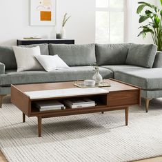 a living room with a sectional couch and coffee table