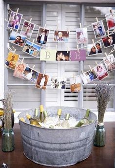 an old metal tub with pictures hanging from it