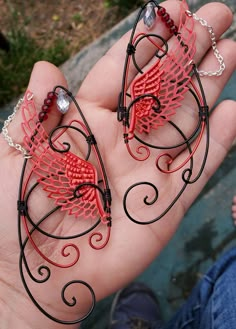 Wings Red and Black You will receive a right and a left with this order. This is made to order in 3 to 5 business days of purchase. Elf ear cuffs are lightweight, stylish and one size fits all. You'll find a pair that is suitable for any event be at the Renaissance Fair, a fairy festival, or just a fun night out on the town! All Elf Ear Cuffs are made with artistic wire, silver plated non-tarnish copper, Nickel free. All Cuffs come as a set and easily fit any size ear by gently adjusting the bac Adjustable Red Fantasy Jewelry, Fantasy Red Jewelry For Party, Red Fantasy Jewelry For Cosplay, Whimsical Red Party Jewelry, Red Fantasy Jewelry, Black Elf, Elf Ear, Elf Ear Cuff, Fantasy Earrings