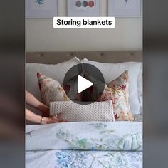 a woman laying in bed with pillows on top of it and the caption reads, storing blankets