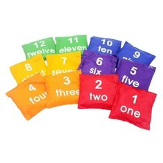 six colorful pillows with numbers on them and one number in the middle, sitting next to each other