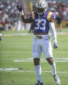 a football player holding his hand up in the air