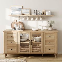 a wooden cabinet with dishes and cups on it