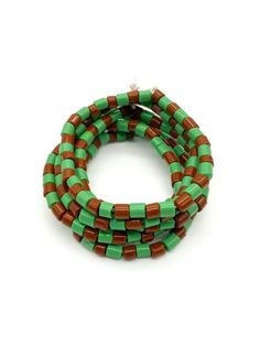 three green and brown beads on a white background