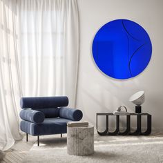 a living room with a blue circle on the wall next to a chair and table