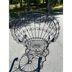 a metal basket sitting on the side of a road