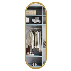 a mirror that is on the wall next to a shelf with clothes and shoes in it