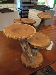 three tree stumps are stacked on top of each other in the middle of a room