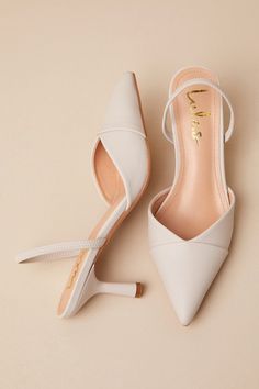 Simple and sophisticated, the Lulus Verenna Ivory Pointed-Toe Slingback Pumps were made to make you look instantly iconic! Smooth faux leather shapes these ultra-chic heels that have a pointed-toe upper with a tonal, overlapping toe cap and a V-cut collar. An elastic slingback strap and a unique sculpted heel complete the sleek design! Available in whole sizes only. 2. 75" sculpted spool heel. Cushioned insole. Rubber sole has nonskid markings. Man made materials. Imported. Lulus | Verenna Ivory Elegant Cream Slingback Pumps With 4-inch Heel, Chic Kitten Heels With Wrapped Heel, Cream Pointed Toe Slingback Sandals, Classic Cream Slingback Pumps With Ankle Strap, Chic Beige Slingback Pumps With Sculpted Heel, Chic Beige Pointed Toe Slingback Sandals, Chic Beige Slingback Pumps With Low Heel, Elegant Beige Kitten Heels With Ankle Strap, Chic Beige Kitten Heels With Sculpted Heel