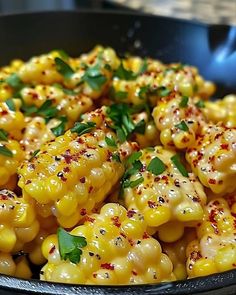 corn with herbs and seasoning in a skillet