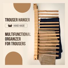 there is a wooden rack with clothes hanging on it and the words, trouser hanger hand made multifunctional organizer for trousers