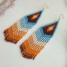 These long beaded earrings are inspired by native American patters. Handcrafted with meticulous attention to detail, they exude timeless sophistication. Perfect for adding a touch of celestial charm to any ensemble, these earrings are sure to become a cherished addition to your jewelry collection. Dimensions: - Length: 10 cm (3.9 inches) - Width: 3 cm (1.2 inches) Southwestern Dangle Beaded Earrings For Festivals, Southwestern Style Beaded Dangle Earrings For Festival, Southwestern Style Dangle Beaded Earrings For Festivals, Bohemian Long Drop Tassel Earrings With Colorful Beads, Bohemian Long Drop Earrings With Colorful Beads, Bohemian Handmade Teardrop Tassel Earrings, Handmade Teardrop Bohemian Tassel Earrings, Bohemian Teardrop Beaded Fringe Jewelry, Bohemian Long Drop Beaded Earrings