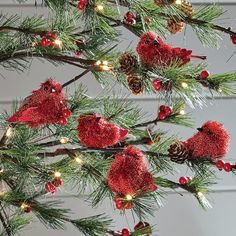 a christmas tree with red ornaments and pine cones