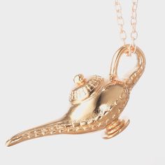 a gold necklace with a bird shaped object on it