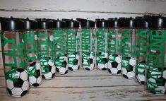 there are many cups with soccer balls in them