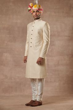 Gold sherwani with floral motifs, patch pocket and mandarin collar. Paired with kurta, and pyjama.
Components:3
Type of Work:Floral
Neckline:Mandarin
Sleeve Length:Full Sleeves
Fabric:Viscose Brocade, Cotton Silk
Color:Gold
Other Details:
Note: Head accessory worn by the model is not for sale
Occasion:Groom, Wedding - Aza Fashions Gold Sherwani, Brocade Kurta, Sherwani For Men, Safari Shirt, Gold Brocade, Nehru Jackets, Formal Suits, Down Vest, Designer Gowns