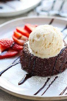 a chocolate dessert with ice cream and strawberries