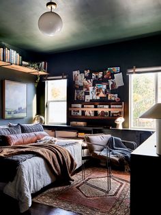 a bedroom with black walls and wooden floors