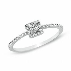 a diamond engagement ring with diamonds on the band and an square shaped center stone in the middle