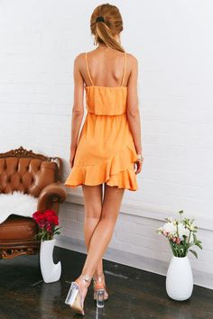 Orange dress. Partially lined. Cold hand wash only. Model is a standard XS and is wearing XS. True to size. Non stretchy fabric. No zipper, slip on style. Cotton/polyester. Be quick, our Dry Your Eyes Dress is going to sell out fast! It features a round neckline, adjustable shoulder straps and it has an overlay on the bodice. It also has a drawstring waist with silver stoppers and a ruffle hem. We love wearing ours with sneakers and a bucket bag! Dress Orange, Cold Hands, Sell Out, Orange Dress, Stretchy Fabric, Ruffle Hem, Your Eyes, Drawstring Waist, Shoulder Straps