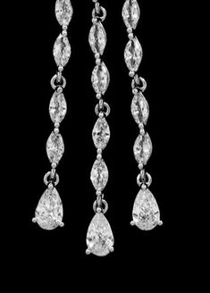 three pairs of earrings with pear shaped diamonds hanging from the bottom, and two smaller pear shaped