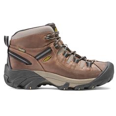 a pair of brown hiking boots on a white background