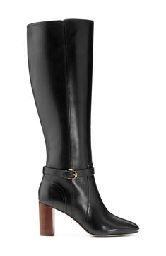 A buckled ankle strap creates a modern aesthetic on a knee-high leather boot furnished with a cushioned footbed and lifted by a stacked heel. 2 3/4" heel 15" shaft; 15 1/4" calf circumference Side zip closure Cushioned footbed Leather upper/textile and synthetic lining/leather sole Imported Fitted Calf Leather Boots With Buckle Closure, Ankle Strap Boots With Buckle Closure For Work, Buckle Closure Ankle Boots For Work, Leather Wide Calf Knee-high Boots With Buckle Closure, Wide Calf Boots With Buckle Closure For Work, Knee-high Boots With Buckle Closure For Work, Classic Boots With Buckle Closure And Medium Width, Wide Calf Leather Heeled Boots With Buckle Closure, Leather Wide Calf Heeled Boots With Buckle Closure