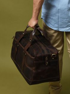 Here is the perfect blend of sophistication and style with our unique leather duffle bag in a rich, textured coffee bean hue, accented by sleek black handles. The full-grain buffalo leather adds to the endurance yes well as the charm of the duffle bag. Best for short trips and routine journeys. Elevate your travel game with this distinctive accessory today! Salient Features Made of grain buffalo leather Pure brass hardware with bottom studs to protect the bag Adjustable leather shoulder strap with padding Consists of a large central compartment with one front zipped pocket for easy access. Can be used as a carry-on bag on airplanes Size Available 20 L x 9 H x 8 W Inches / 48.26 L x 22.86 H x 20.32 W Cms Brown Leather-lined Luggage For Travel, Classic Brown Luggage For Overnight Trips, Classic Brown Travel Bag With Luggage Sleeve, Classic Brown Weekender Bag For Overnight Trips, Classic Brown Luggage With Leather Trim, Classic Brown Travel Bag With Leather Trim, Luxury Brown Satchel For Overnight Trips, Brown Leather Travel Bag With Large Capacity, Brown Leather Travel Bag With Textured Finish