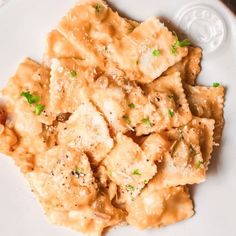 a white plate topped with pasta covered in sauce