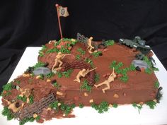 a birthday cake is decorated with horses and people on the farm, including an army tank